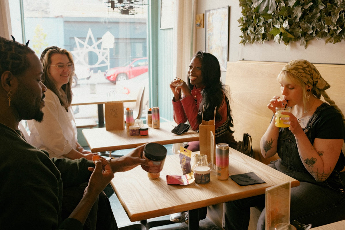 Friends enjoying drinks and Canni products inside the Walker’s Point cafe and infusion bar